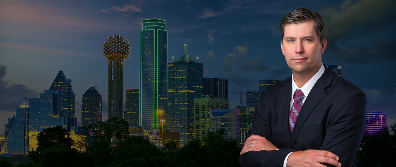 Patrick Kelly with Dallas skyline in the background